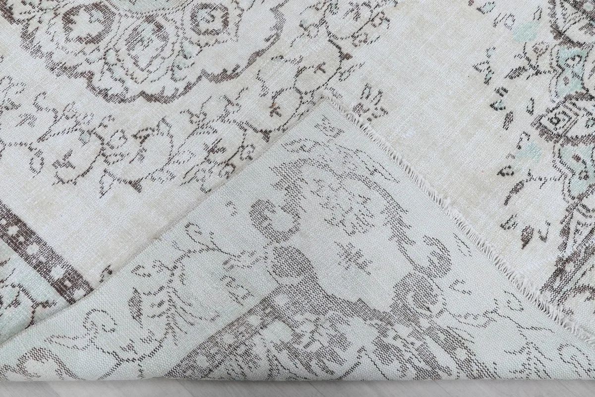 Underside view of the rug, revealing the cotton foundation and hand-knotting