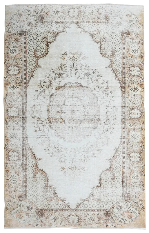 Full overhead view of the cream and beige vintage Anatolian rug with a central medallion.