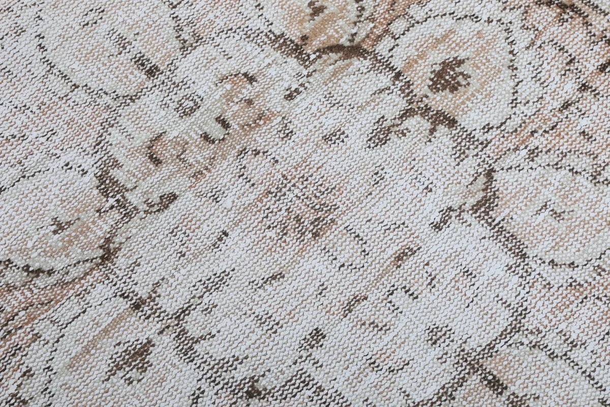 Close-up view of the wool pile texture and hand-knotted weave, showing the low pile and intricate details.