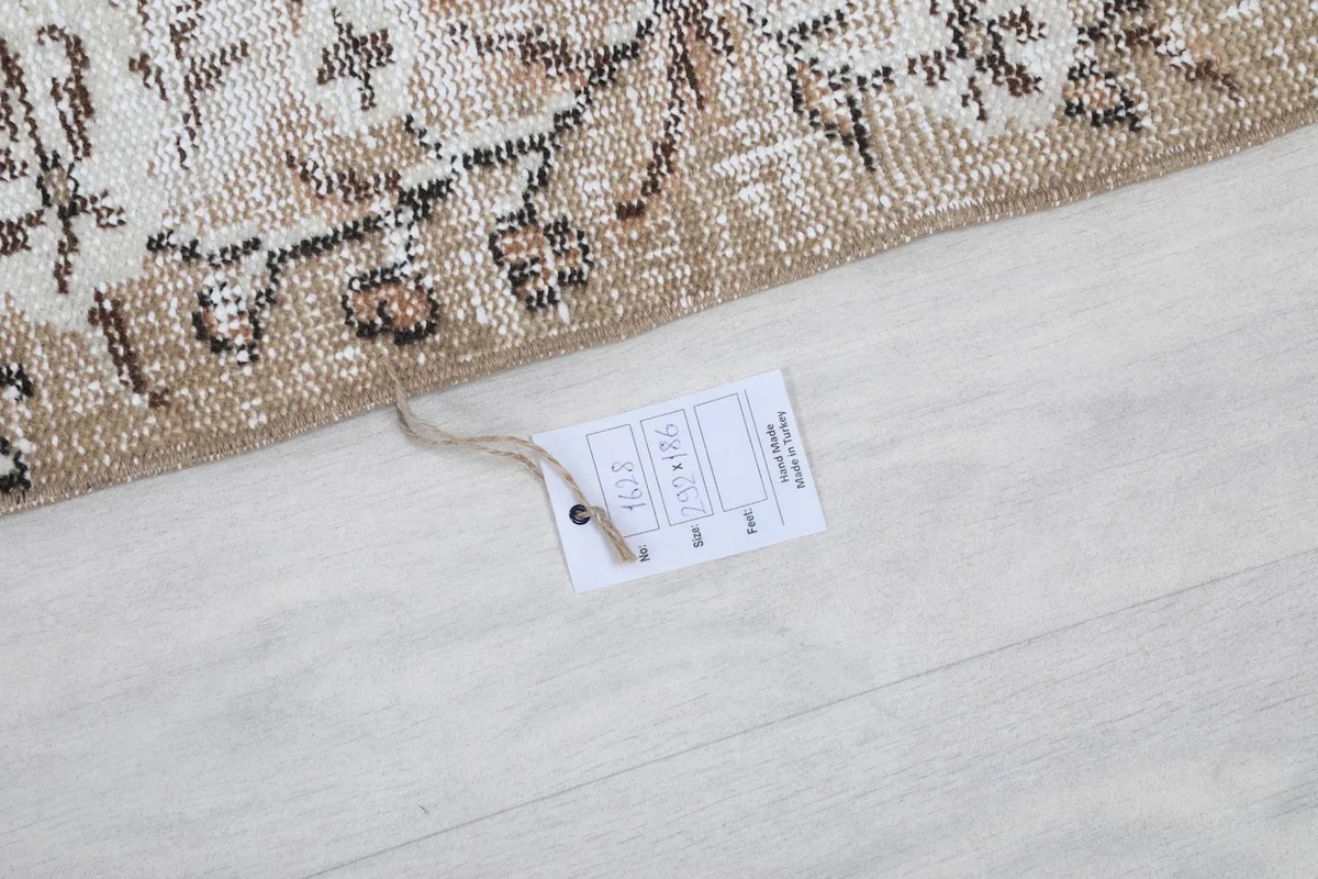 Corner of the rug with a product tag, indicating its origin and material details.