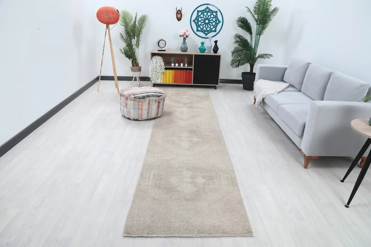 Runner rug displayed in a living room setting with a gray sofa and light flooring