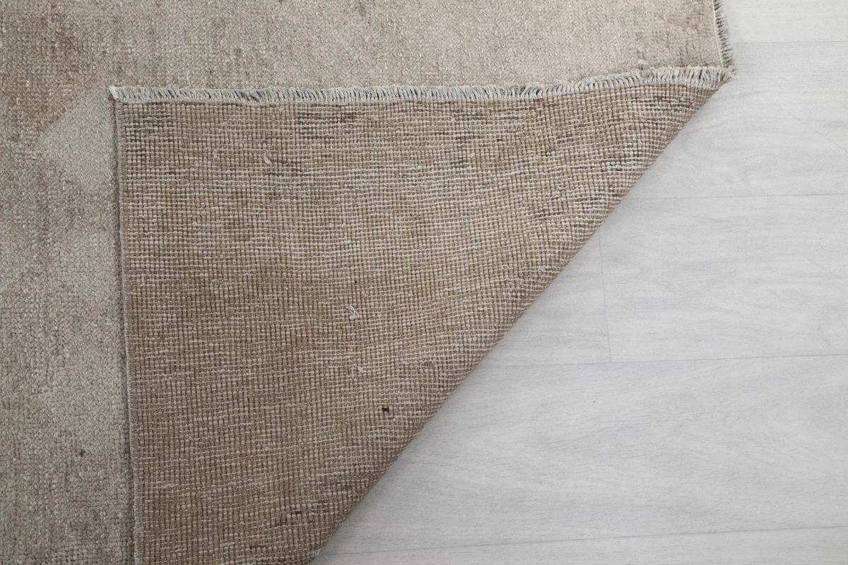 Underside of the runner rug, showing the hand-knotted cotton foundation weave