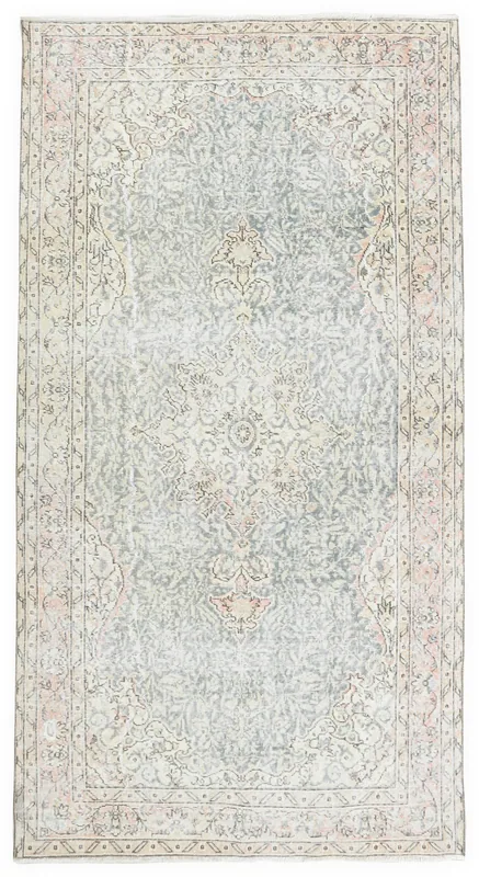Full overhead view of the 5'4" x 8'8" vintage Anatolian rug with faded blue field and rose border.