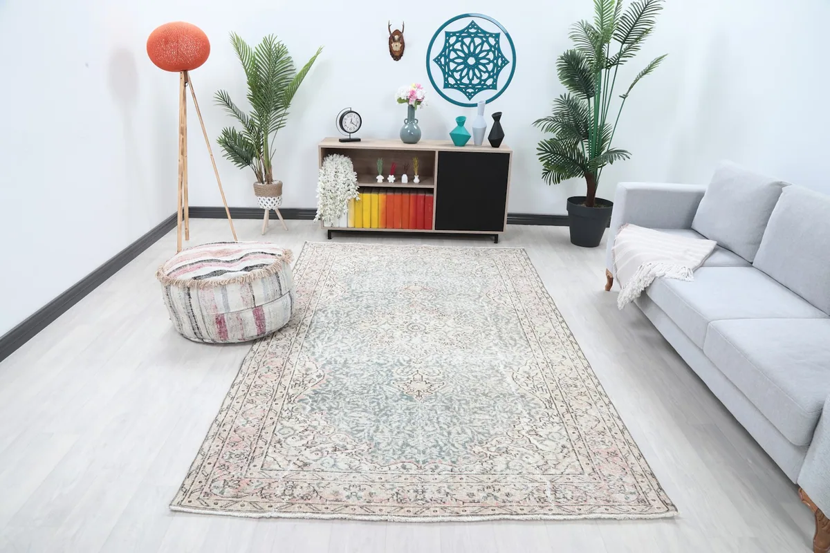 Vintage Anatolian rug displayed in a bright living room setting with modern furniture.