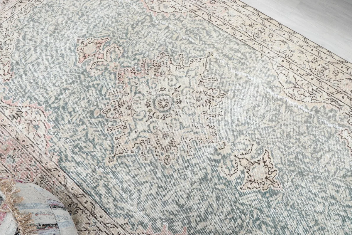 Overhead detail showing the faded blue main field and central medallion motif.