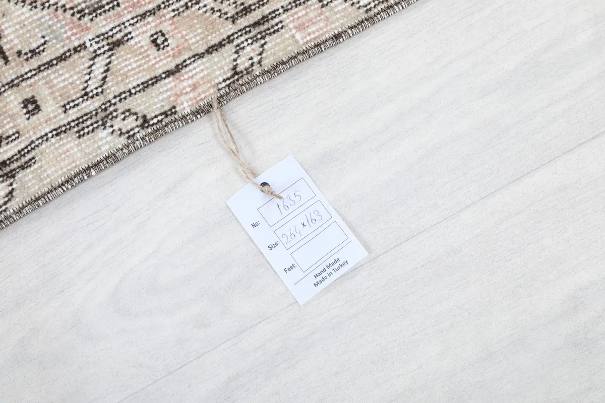 Close-up of the product tag, confirming the rug's origin from Turkey and dimensions.
