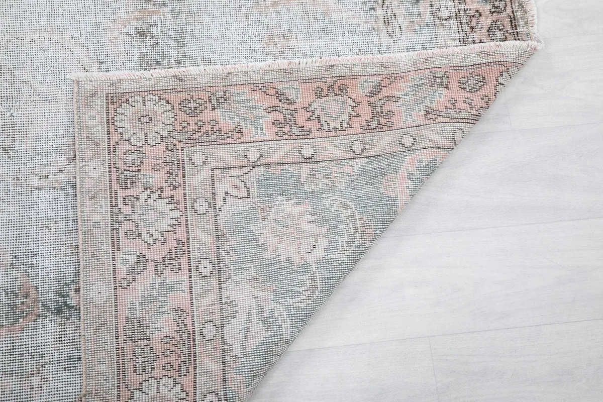 Close-up of the rug's reverse side, revealing the tight hand-knotted construction and foundation.
