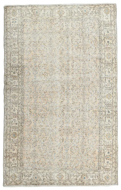 Full overhead view of the beige and blue vintage Anatolian area rug on a white background