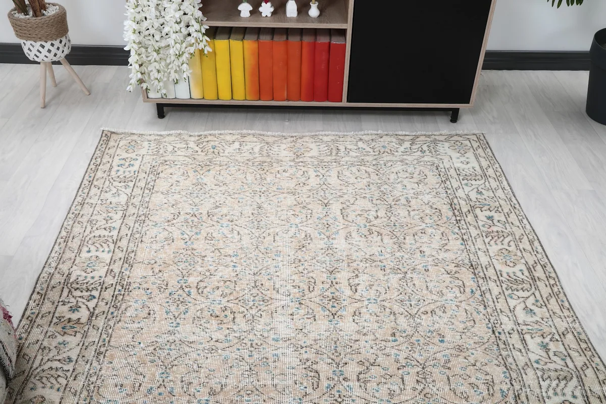 Full room view of the beige and blue vintage Anatolian rug from a higher perspective