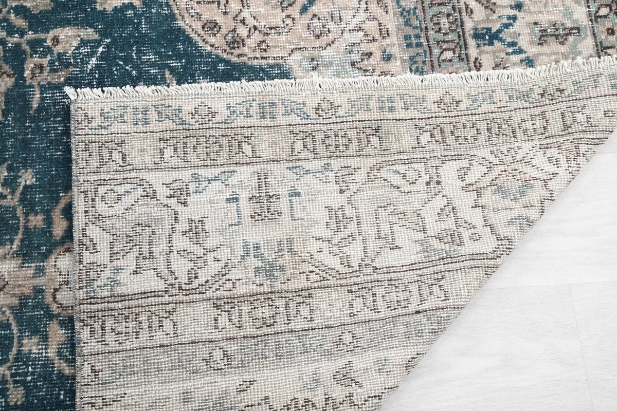 Close-up of the back of the rug, showing the knotting structure and fringe