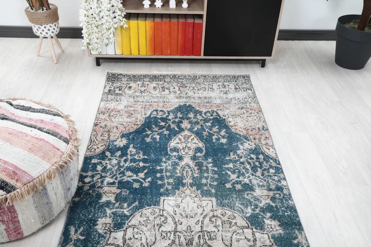 Overhead view of one end of the runner rug, showcasing the faded blue and beige colors