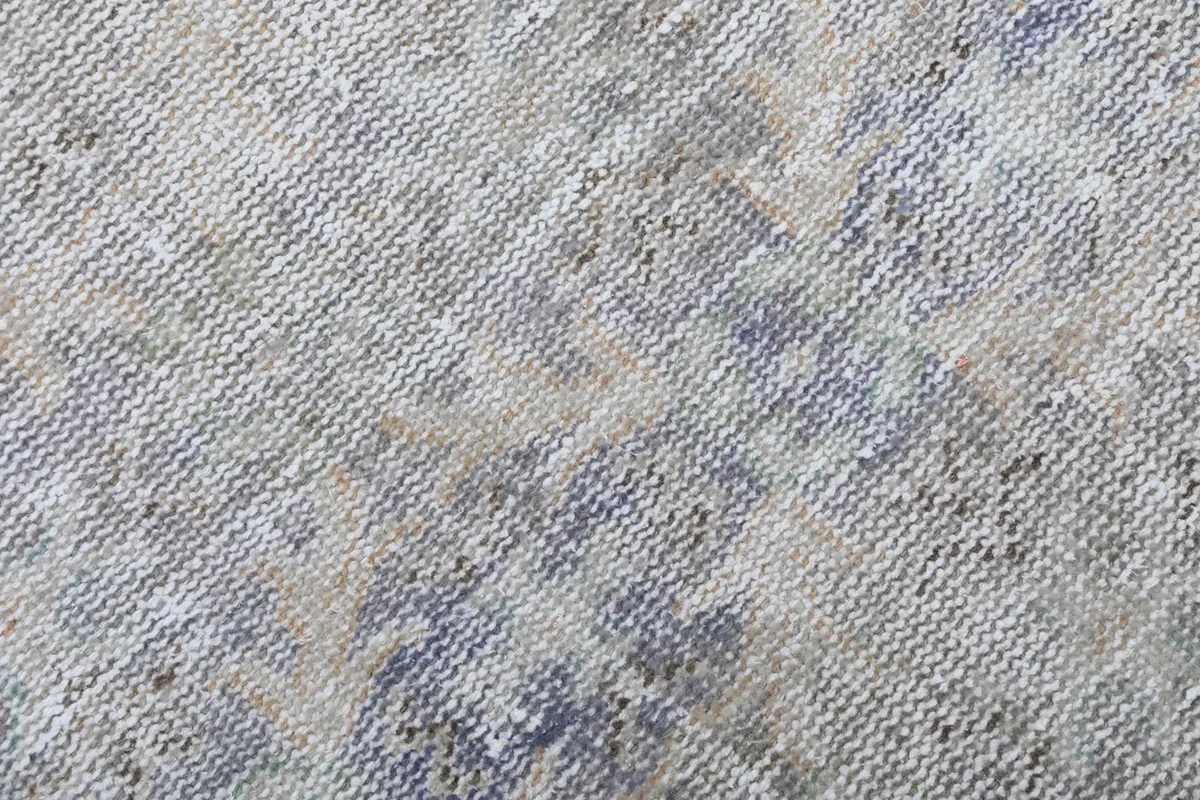 Close-up showing the low wool pile and hand-knotted texture