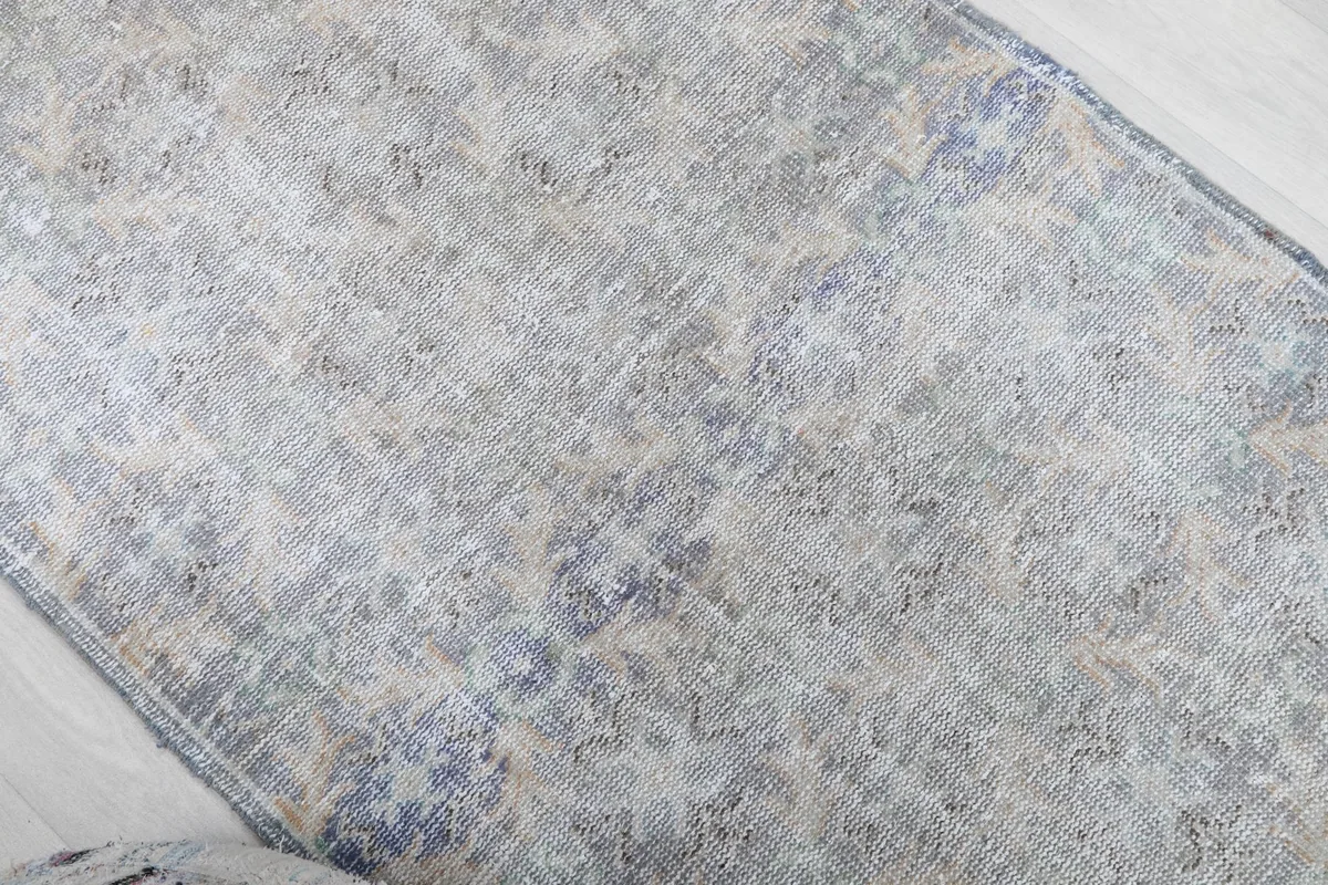 Overhead view focusing on the central part of the rug's faded pattern
