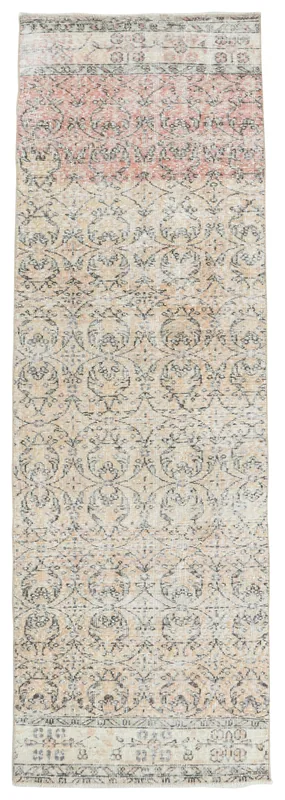 Full top view of the beige and rose vintage Anatolian runner rug on a white background.
