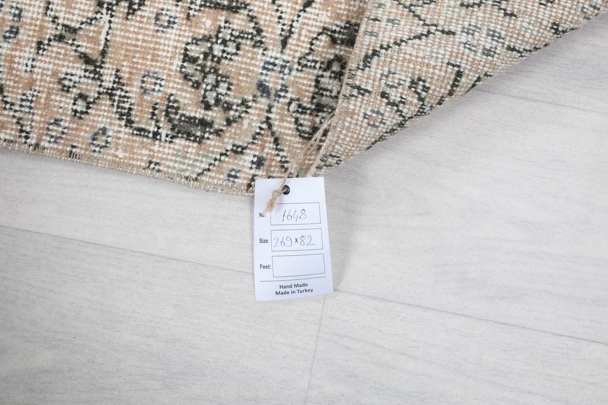 Image showing the product tag attached to the rug, indicating its origin and material details.