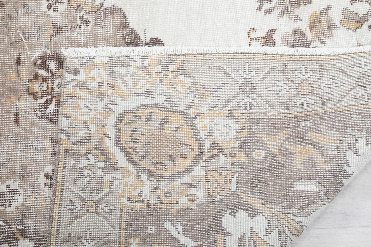 Close-up of the short, natural fringes and the back of the rug, detailing the craftsmanship.