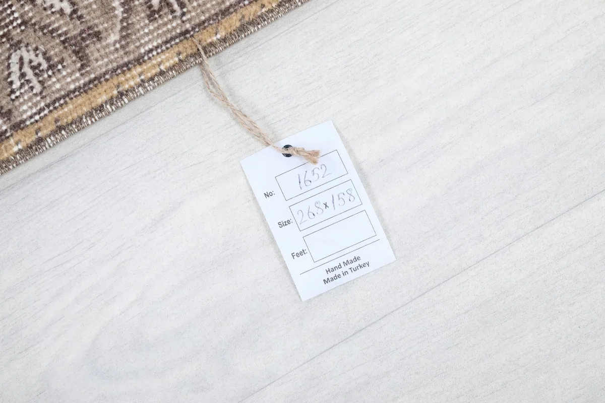 Product tag displaying the rug's dimensions and origin, confirming it is hand-made in Turkey.