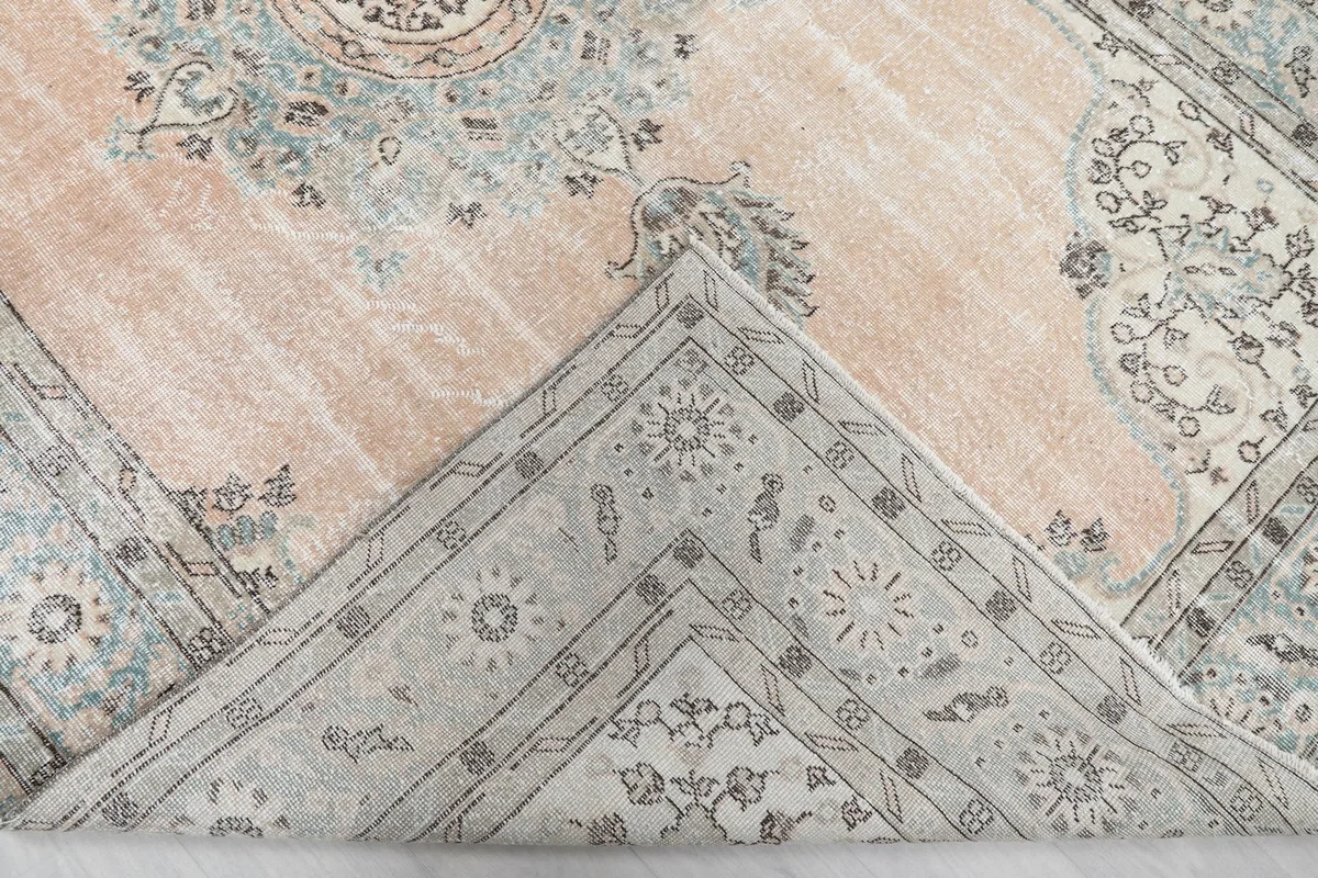 View of the rug's backside, revealing the cotton foundation and hand-knotted construction.