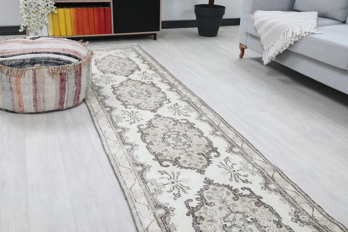 Close-up view of the rug in a room, highlighting the central medallion patterns