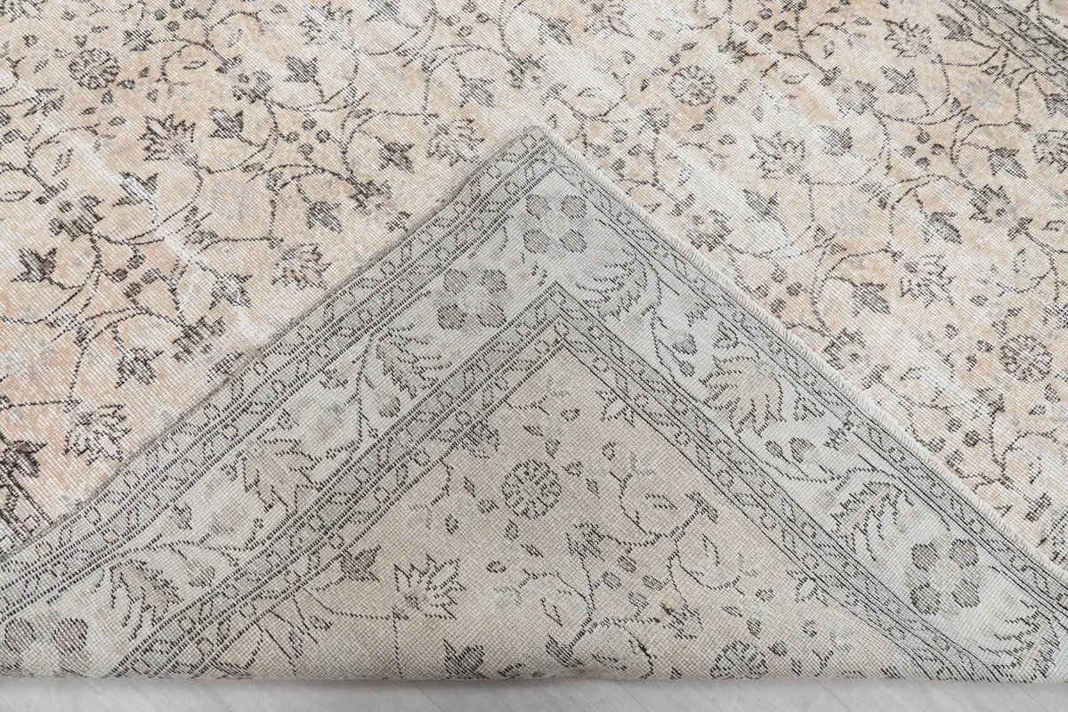 View of the rug's underside, revealing the cotton foundation and hand-knotted construction