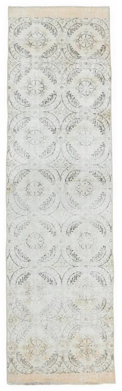 Full overhead view of the 2'7" x 10'1" vintage Anatolian runner rug with ivory and gray floral pattern