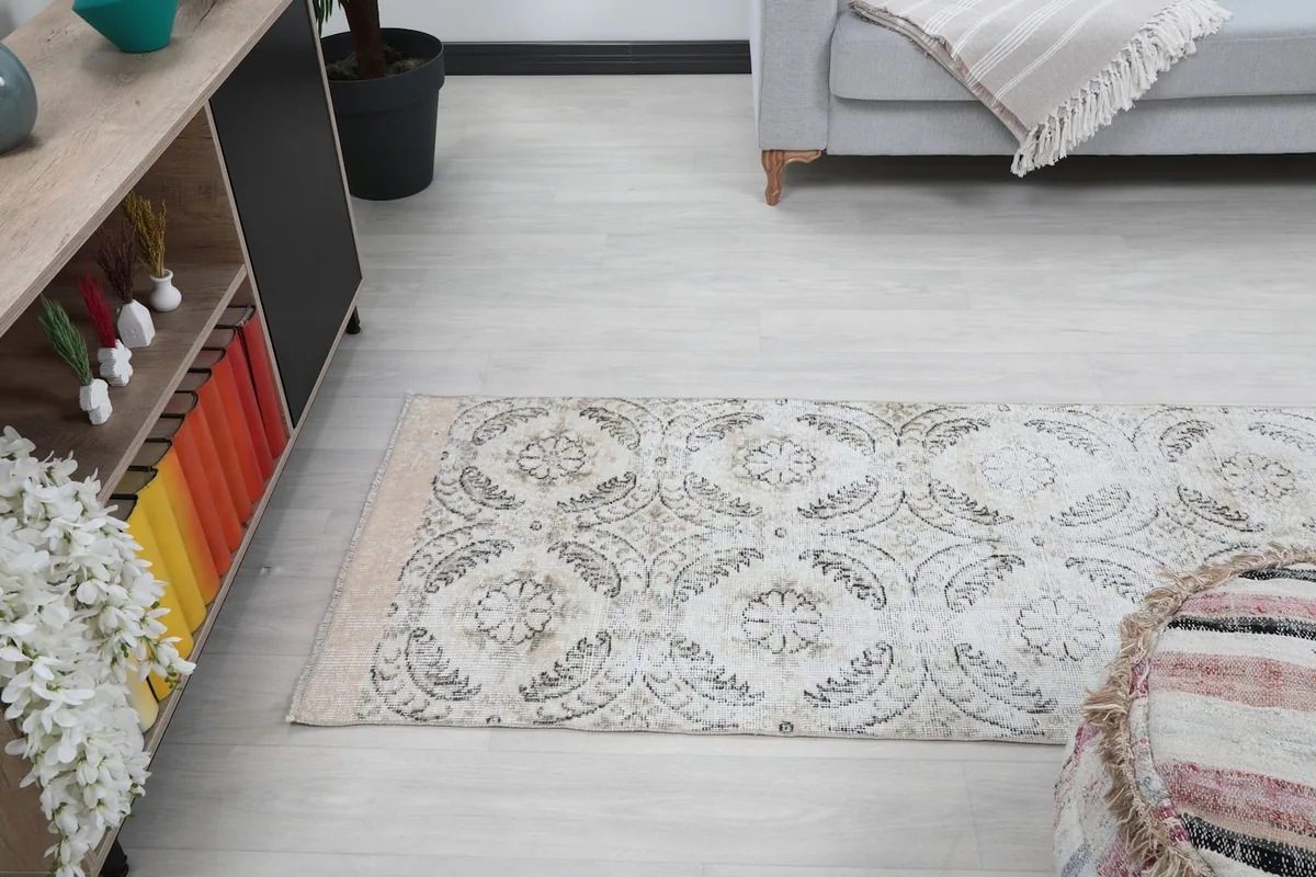 Runner rug extending through a room, viewed from a high angle, showcasing its full length
