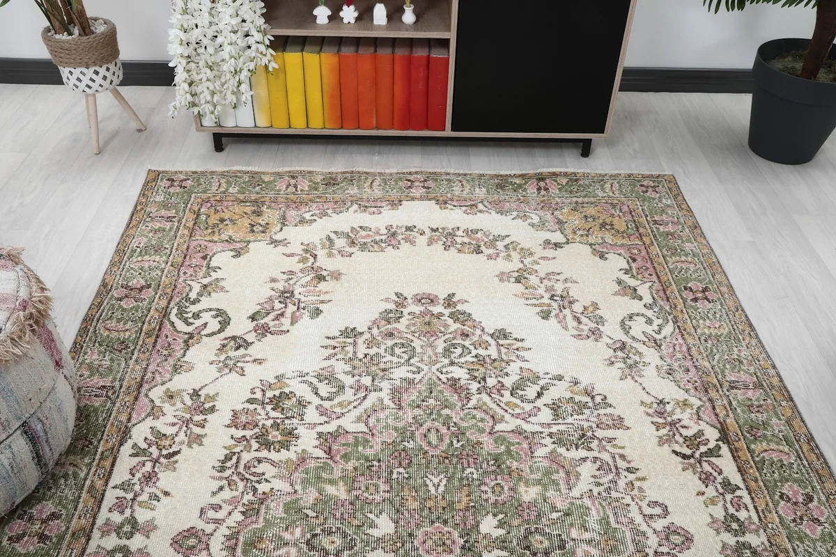 Overhead view of the rug in a room, highlighting the full floral medallion design