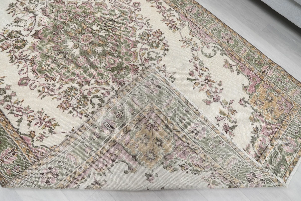 Folded corner of the rug revealing the cotton foundation and reverse side of the knots