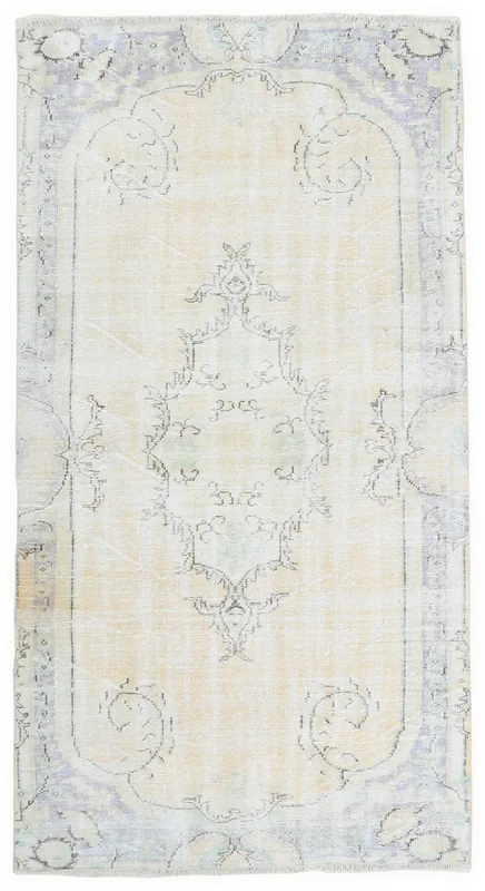 Full overhead view of the 5'1" x 8'2" ivory and gray vintage Anatolian rug on a white background