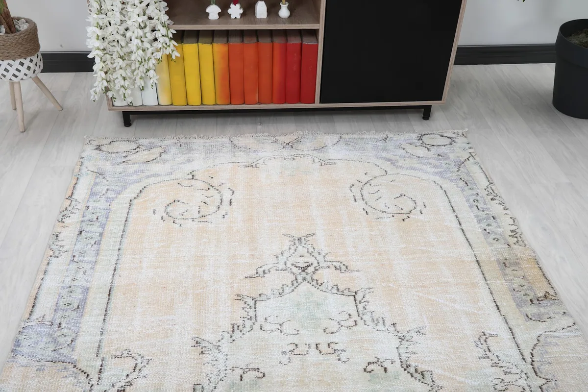 Angled view of the rug's top end, showing the central medallion and decorative border