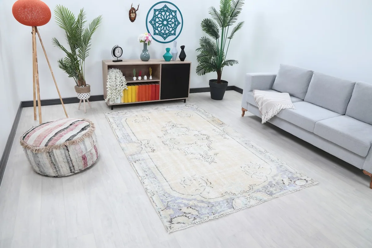 Angled view of the ivory and gray vintage rug in a modern living room with a neutral color palette