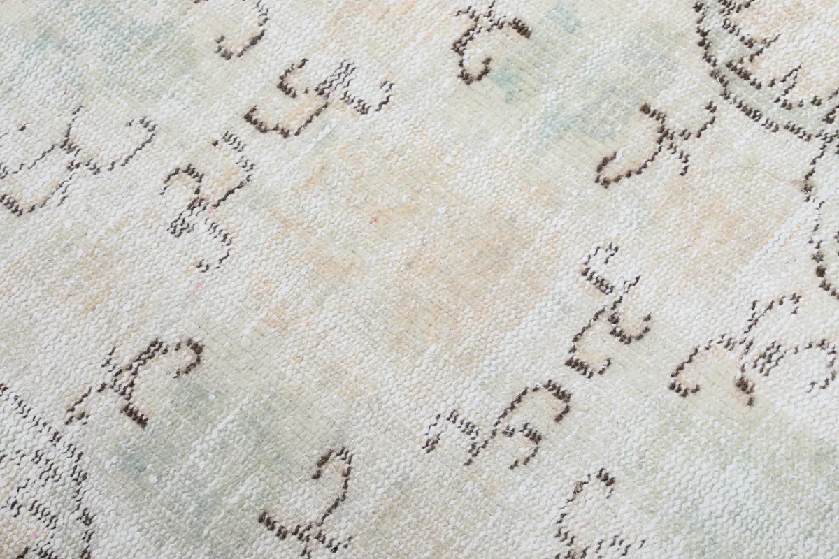 Close-up of the low wool pile and intricate knotting, revealing areas of gentle wear and patina