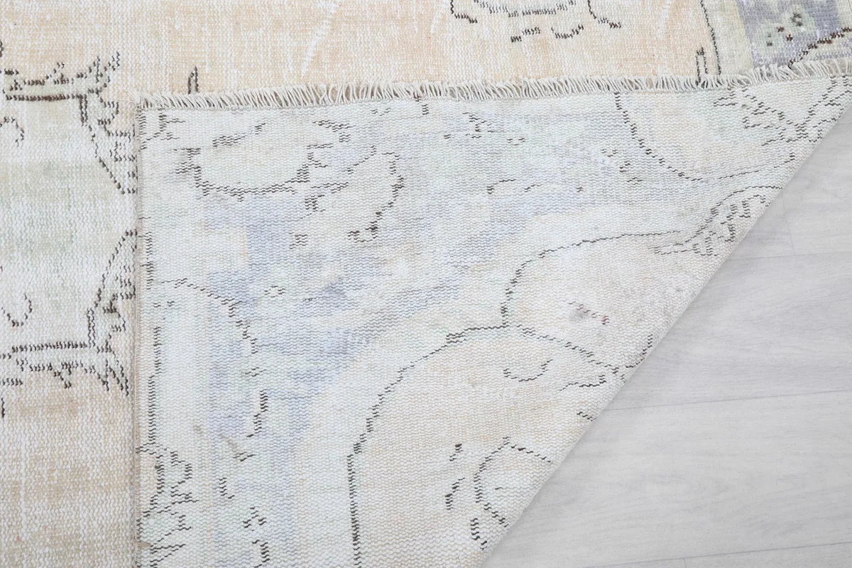 Close-up of the rug's reverse side, showing the tightly woven cotton foundation and craftsmanship