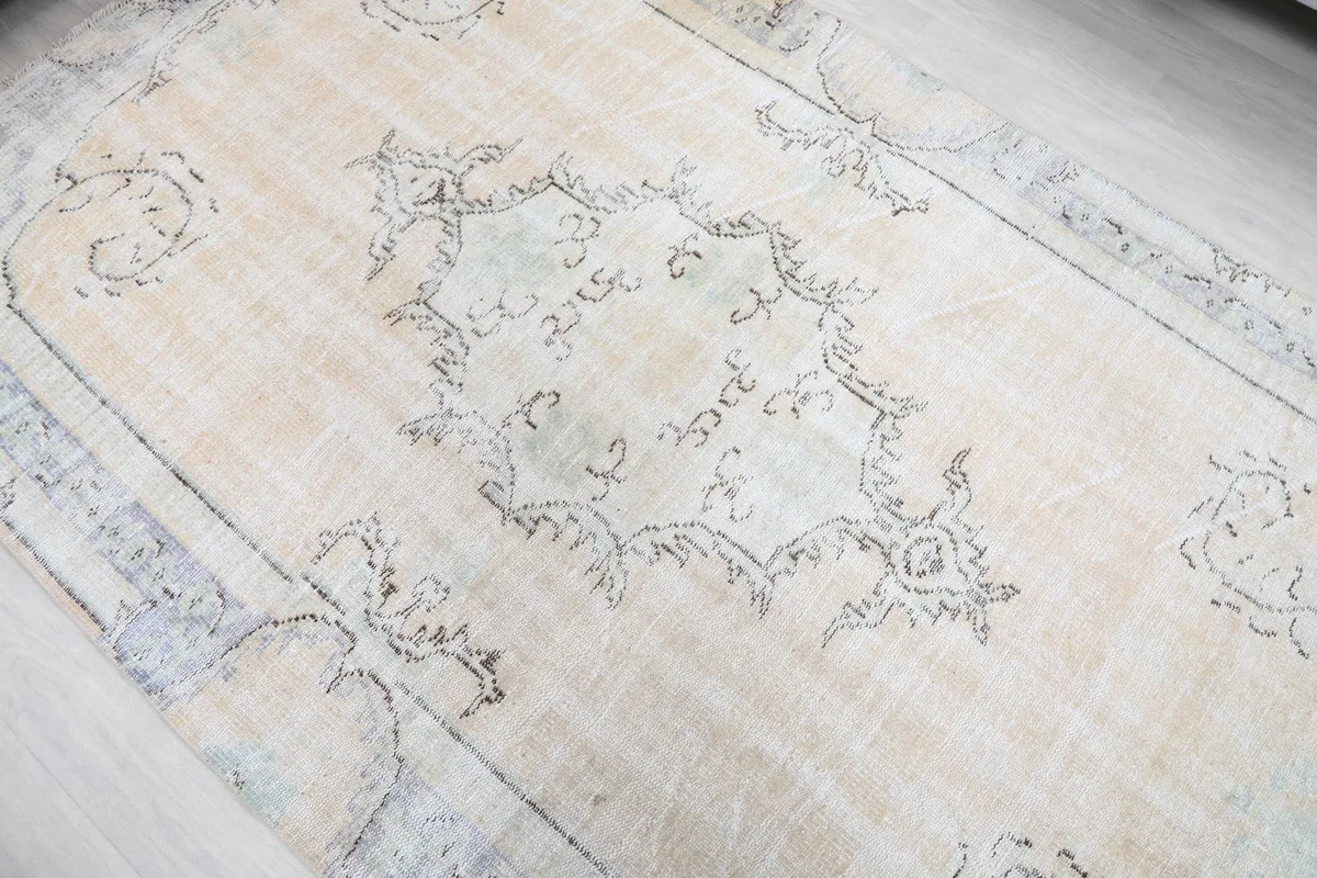 Overhead view of the central medallion and surrounding patterns, showcasing the ivory and gray tones