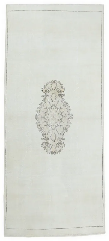 Full top view of the 5'5" x 10'11" ivory vintage Anatolian area rug with a central medallion on a white background.