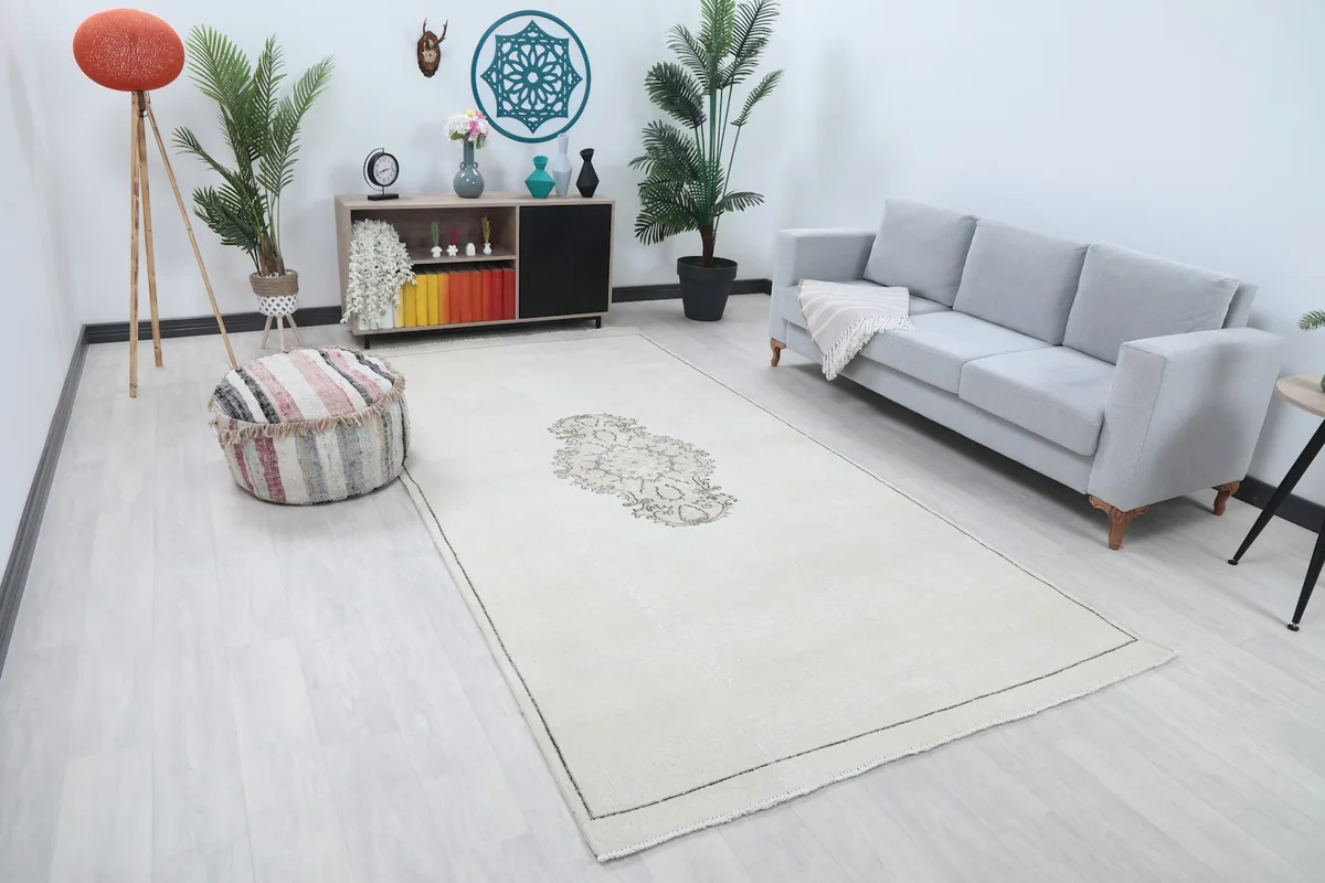 Angle view of the ivory area rug in a living room, highlighting its size and placement with furniture.