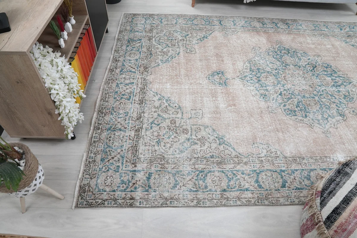 Wide angle view of the beige and blue rug laid out in a living space