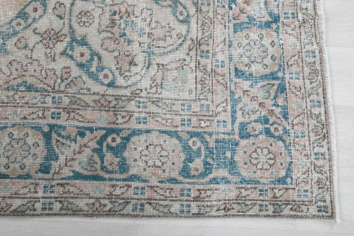 Detailed view of the blue border design and corner motifs of the rug