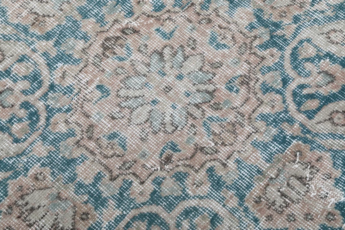 Macro detail of the hand-knotted wool pile showing texture and color variations