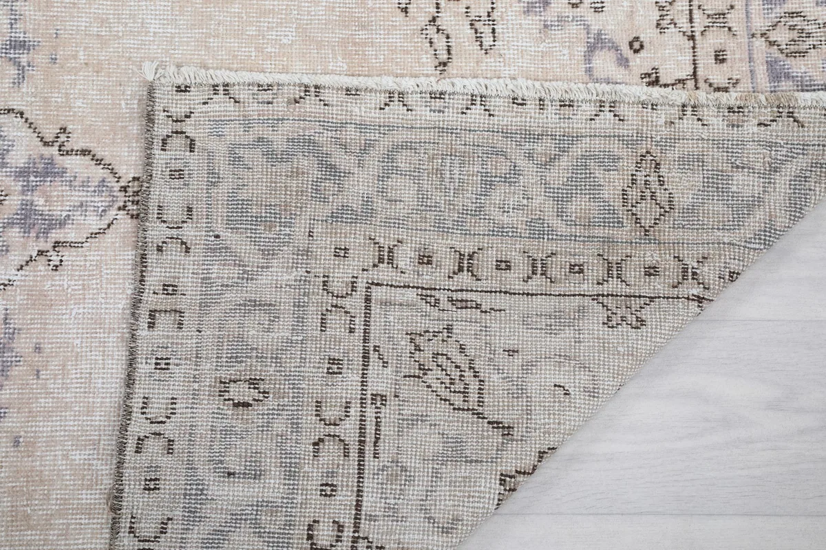 Close-up of the rug's back, revealing the intricate knotting and sturdy cotton foundation