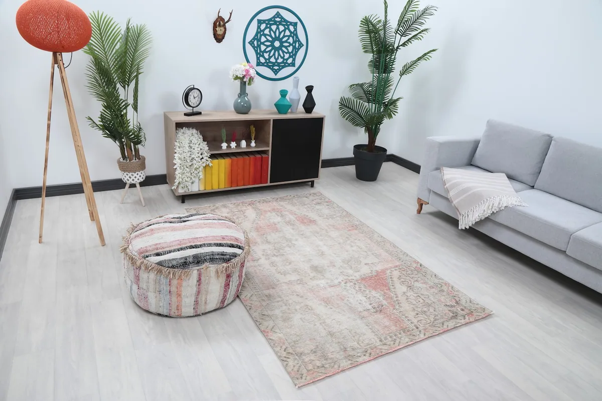 Beige and rose geometric rug displayed in a modern living space