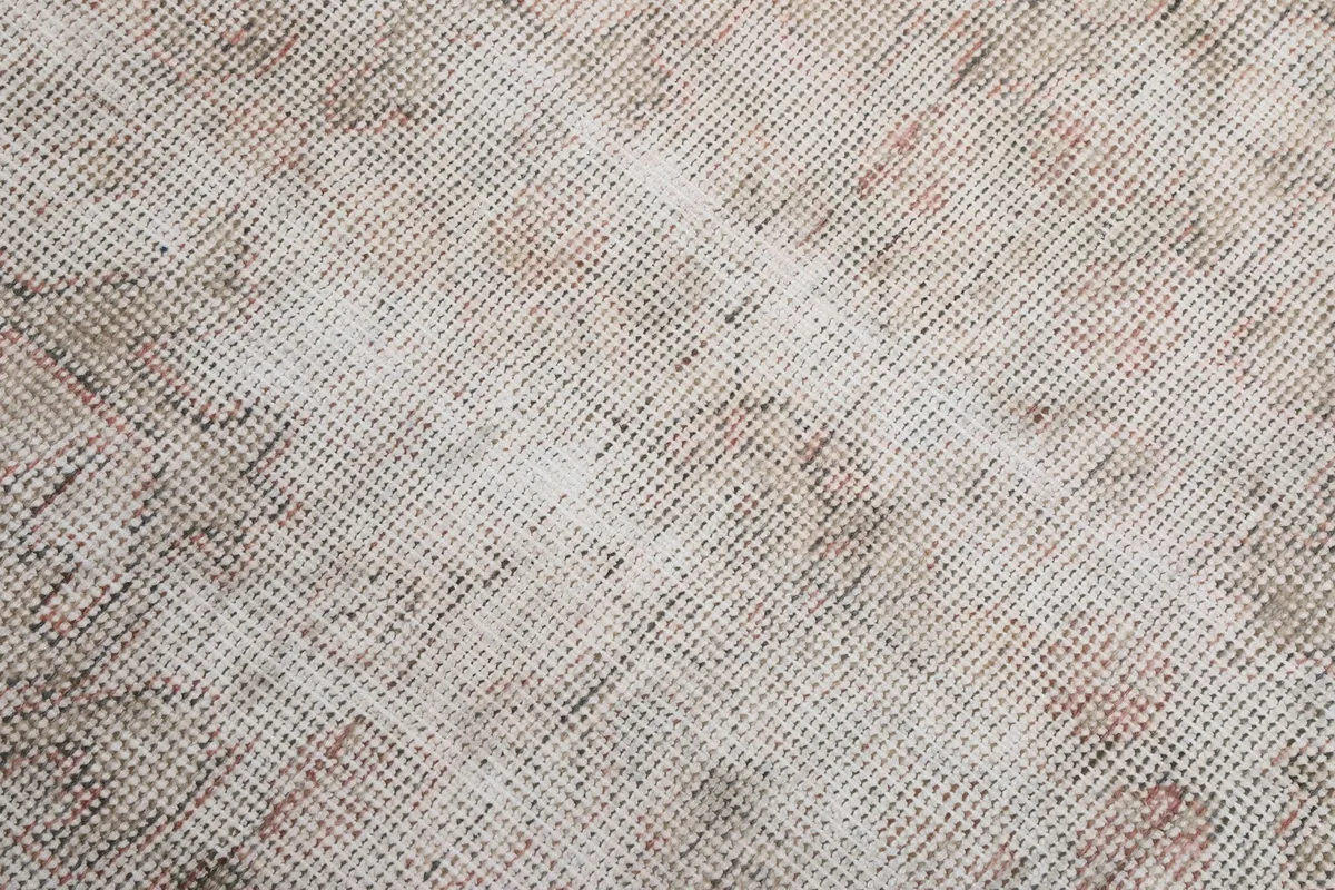 Texture of the hand-knotted wool pile, showing wear and color variation