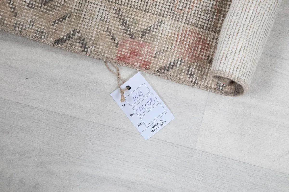 Rolled rug with a product tag, indicating its origin and material