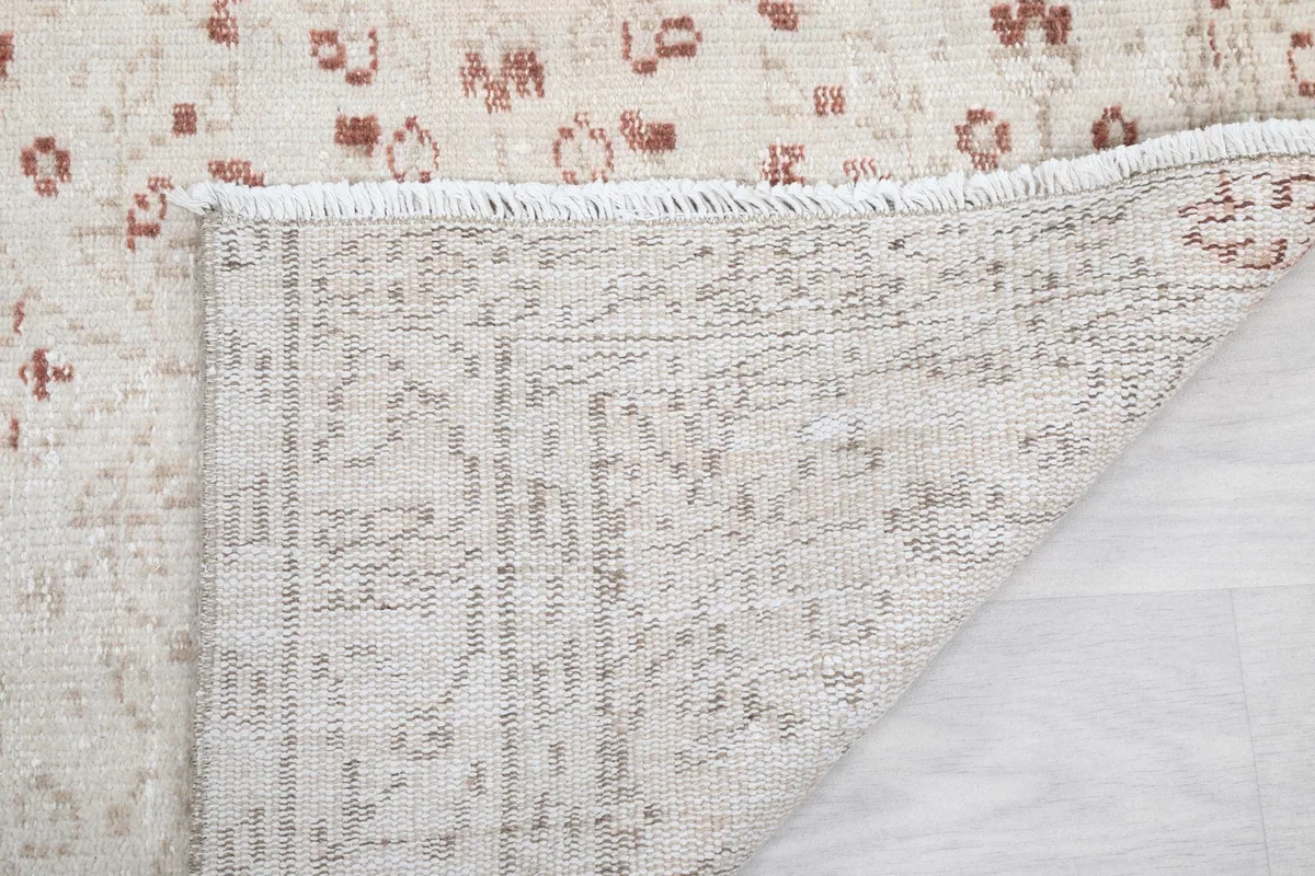 Close-up of the rug's fringe and the back, showing the craftsmanship and knots