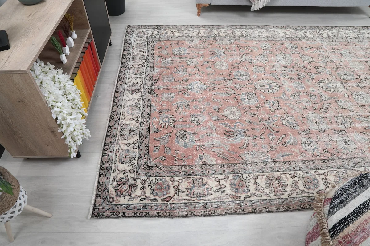 Wide shot of the 6'8" x 10'0" rose rug in a living room, showing its full scale