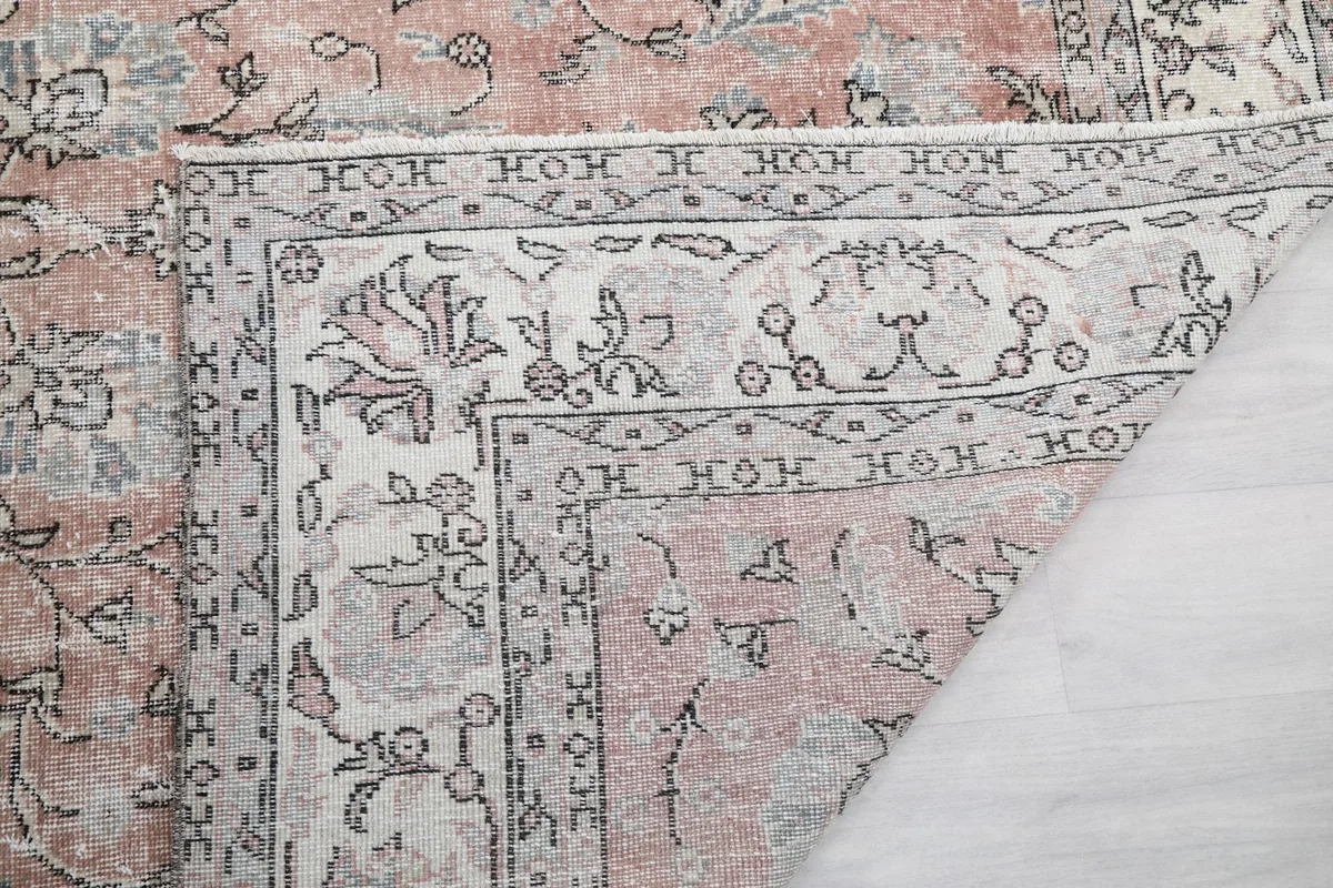 Close-up of the rug's reverse side, showing the knotting structure and fringe detail
