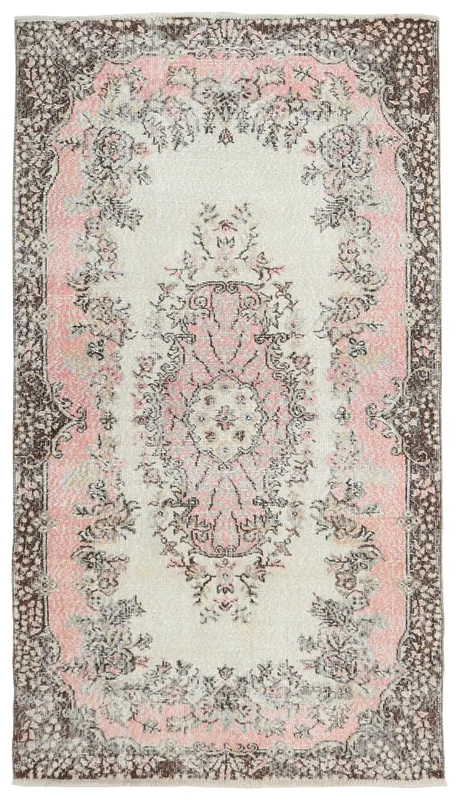 Full top view of the vintage ivory and rose Anatolian rug on a white background