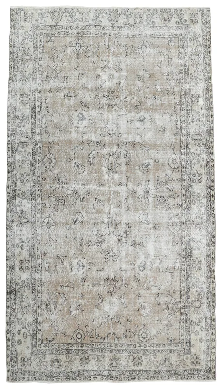 Full overhead view of the beige and gray floral vintage Anatolian area rug