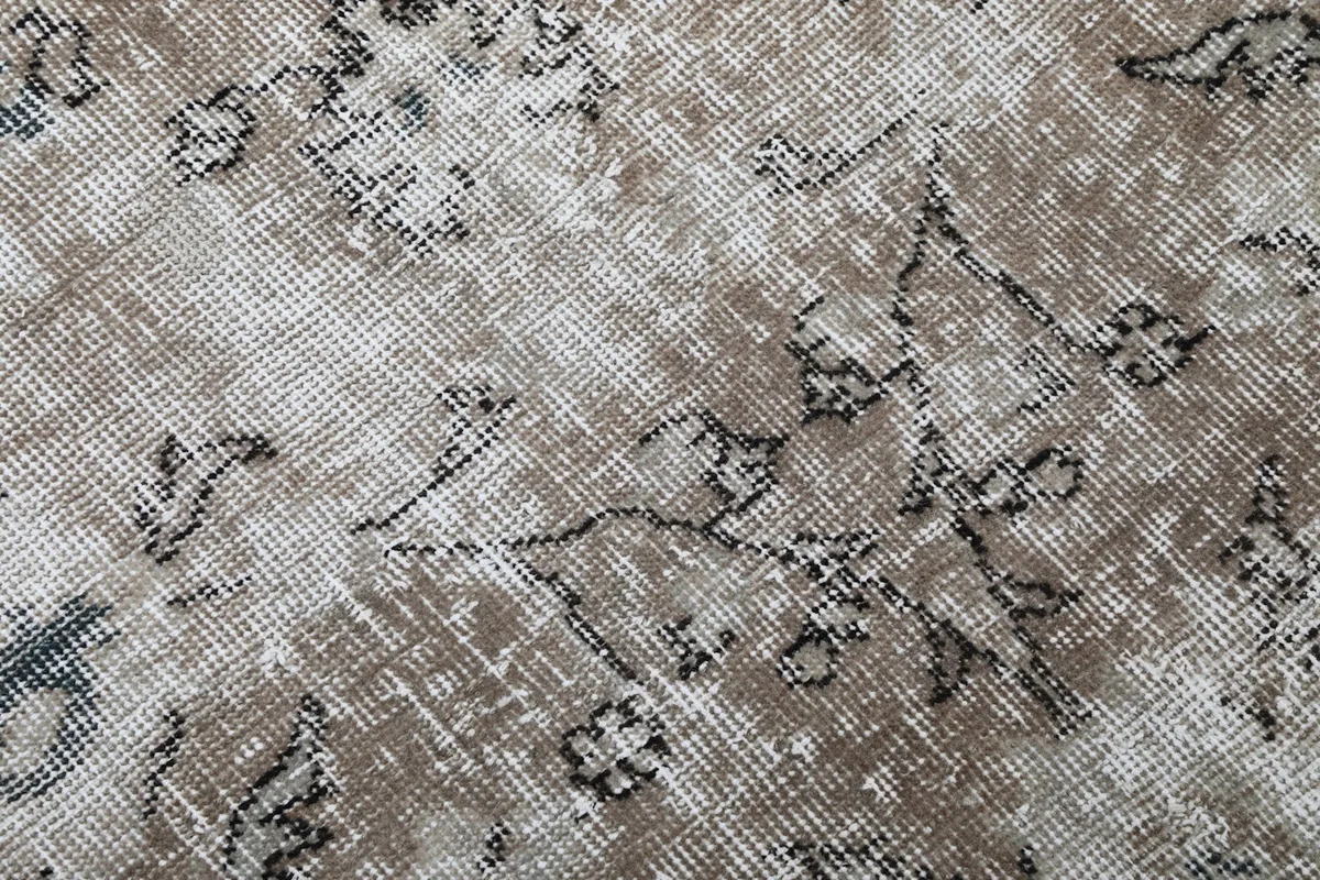 Extreme close-up showing the low wool pile and hand-knotted texture