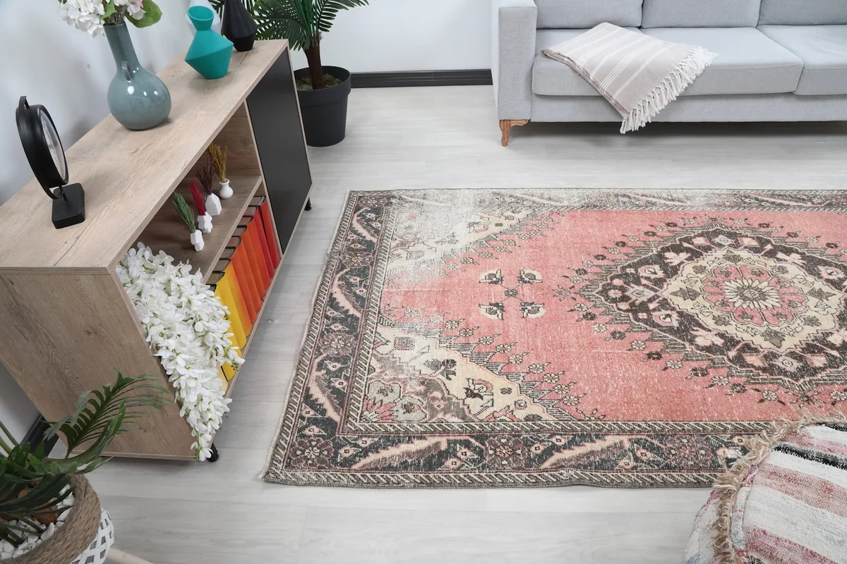 Angled room view of the rose area rug, showing its placement relative to furniture and decor